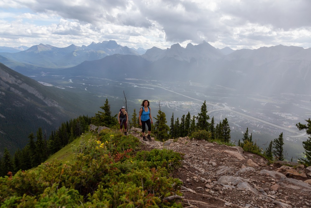Two hikers moving steadily through alpine terrain in the Rockies