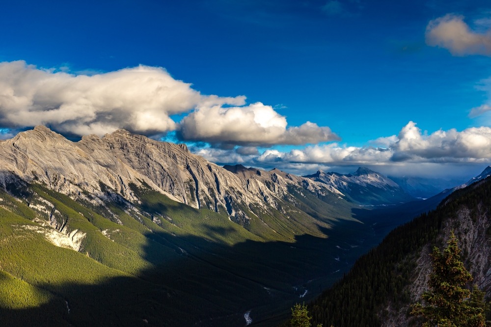 Hiking over a ridge looking down the valley of Bow Valley Provincial Park