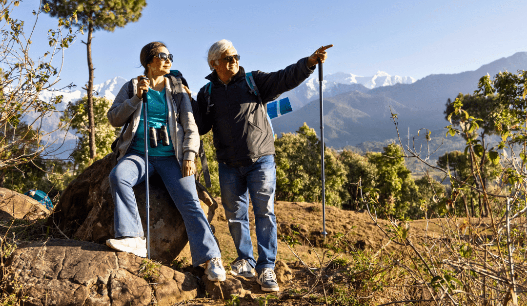 Two senior women resting during a hike in the Canadian Rockies with mountain views