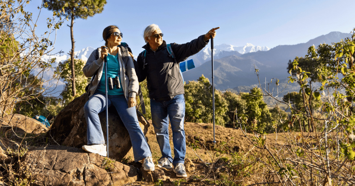 Two senior women resting during a hike in the Canadian Rockies with mountain views