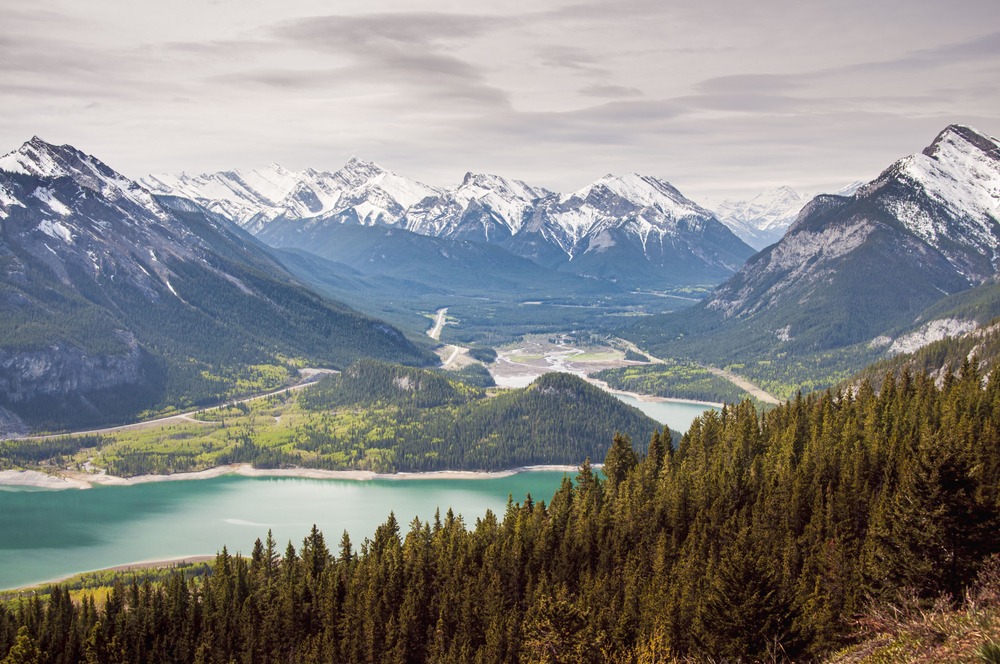 Kananaskis landscape showing green valley and snow-covered alpine peaks in early summer