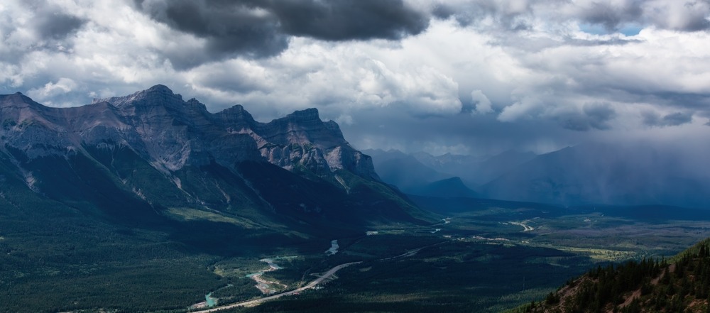 Vertical storm clouds building over a Banff ridgeline in the Canadian Rockies