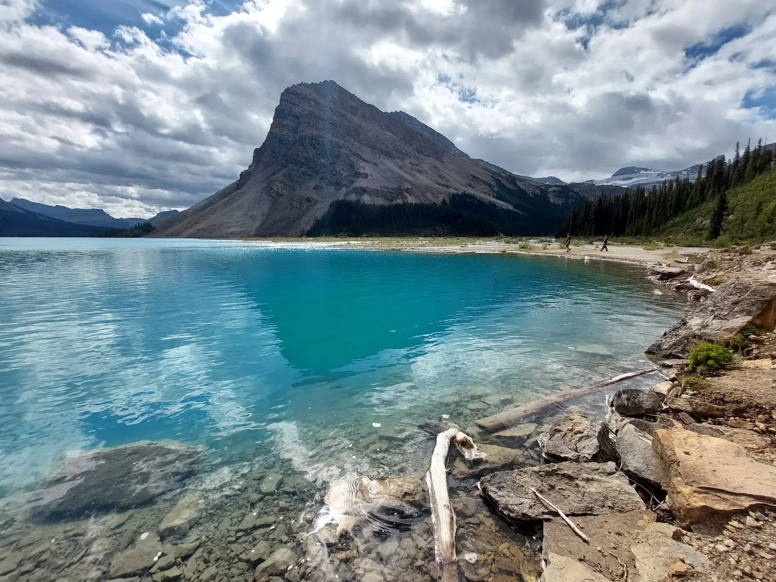 emerald green lake with mountain peak