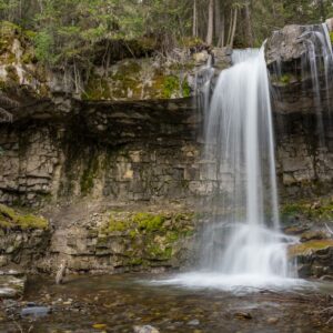 Troll Falls waterfall along a forest trail in Kananaskis on a half-day guided hike